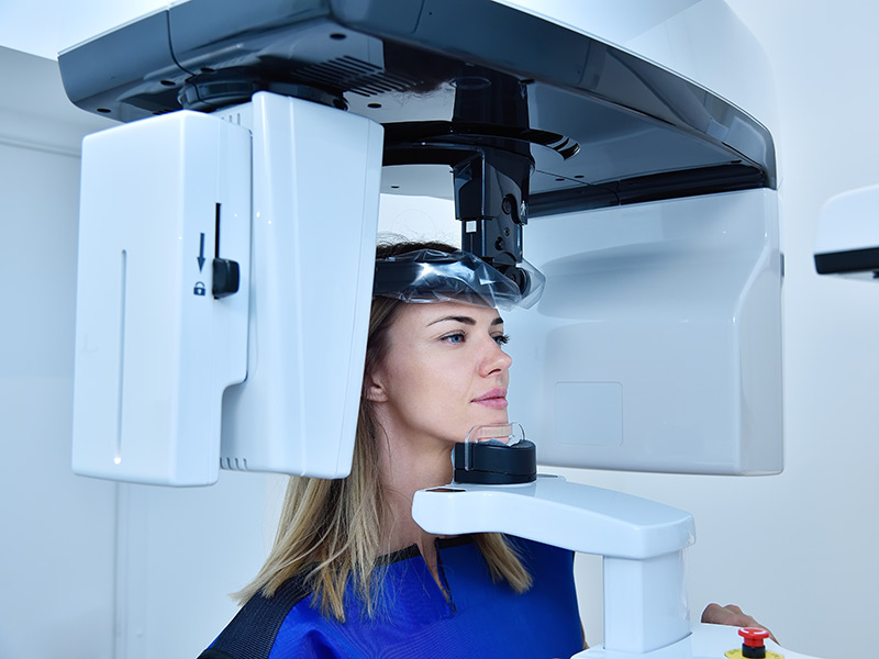 Woman patient make a panoramic computer tomography in clinic.